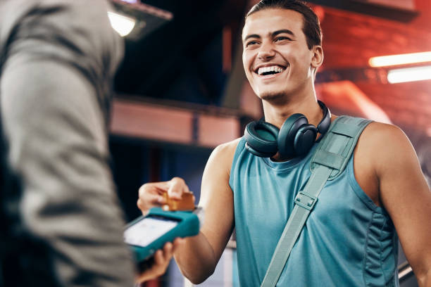 istock Credit card, payment or customer happy with machine for 5g network, customer service or digital sale in gym. Membership discount, fintech or man with employee for support, help or RFID tech in studio 1448290235