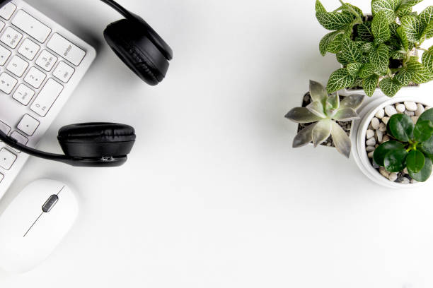 This Digitally Generated Image features a sleek, red Smart Phone with black and gold Wireless Headphones resting on top, set against a dark background. The High Angle View and Flat Lay composition highlight the Simplicity and Elegance of modern Technology. It perfectly illustrates concepts of Music Streaming Service, Podcasting, and Online Messaging. The large, blank Device Screen provides ample Copy Space for app mockups or branding. Ideal for Business, Entertainment, and Telecommunications Equipment marketing, representing the seamless Connection and User Experience of digital Lifestyle and Innovation.
