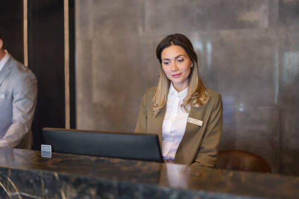 istock Female receptionist at hotel counter 1448294354
