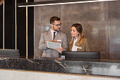 Hotel Receptionists Using Digital Tablet