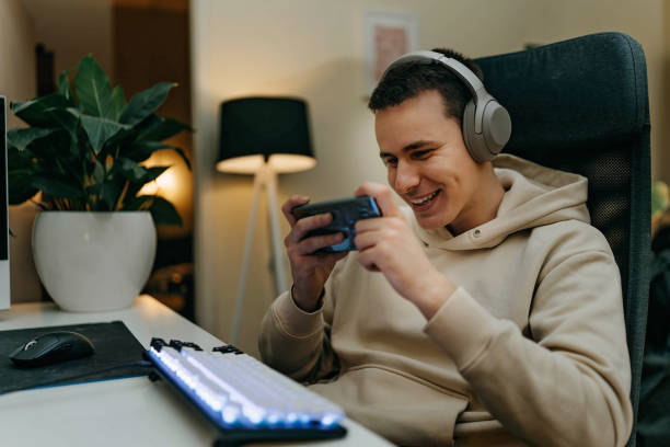 istock Gamer playing games at home 1448296334