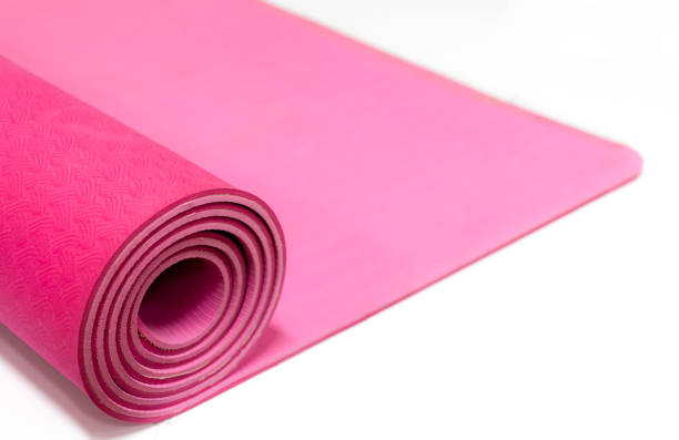 istock Close up pink yoga mat isolated on white background 1448296403