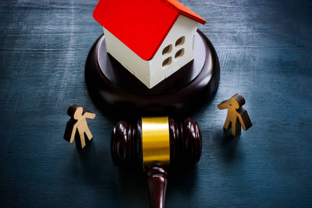 Figurines, a model of a house and a gavel, as a concept of inheritance law. stock photo