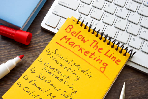 Marks about Below the line BTL marketing in yellow notepad.