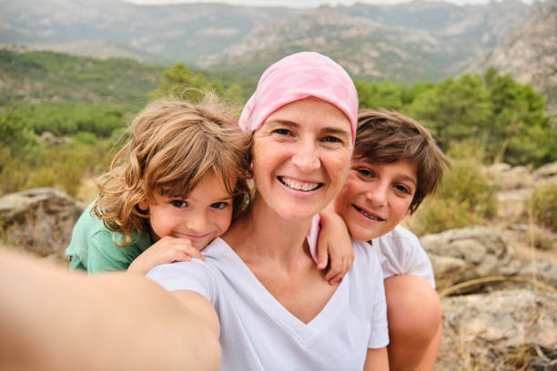 Self-portrait of a woman with cancer and her children stock photo
