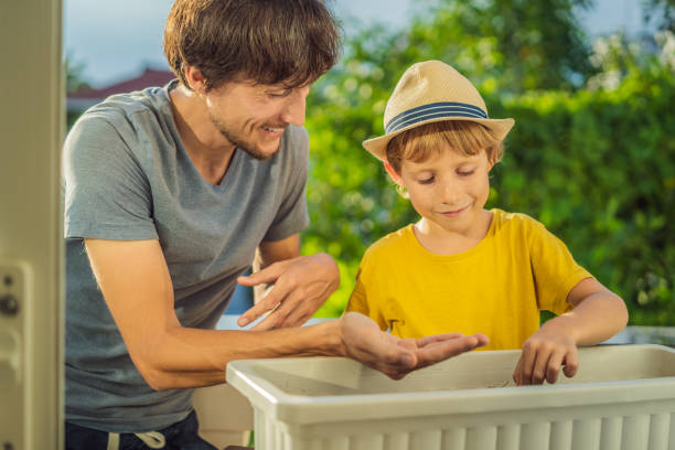 istock Dad and son is doing gardening on his balcony. Natural development for children 1448305850