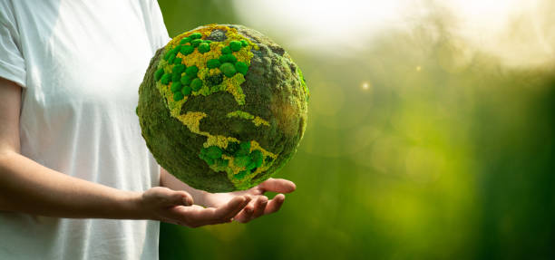 Woman holding a green planet Earth.