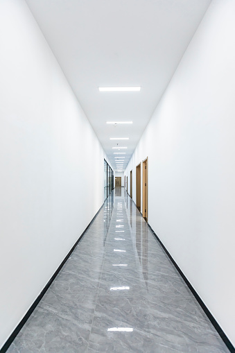 Empty long corridor in the modern building.