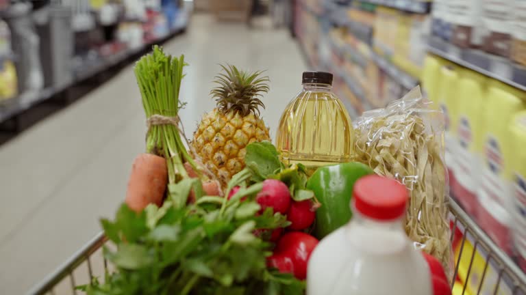 Supermarket, shopping and groceries speed walking for stock market sale, discount or promotion date of customer with trolley. Grocery store, shopping cart and fast retail pov for food commercial deal