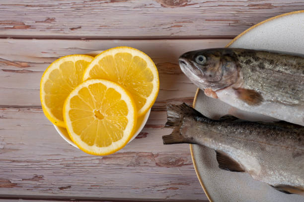 istock fish with lemon - omega 3, vitamin A or E - rainbow trout 1448313856