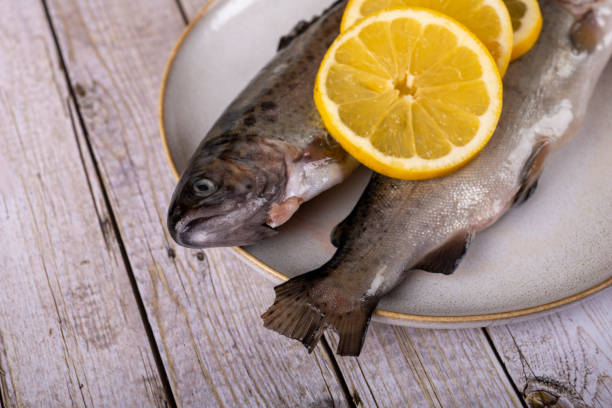 istock fish with lemon - omega 3, vitamin A or E - rainbow trout 1448313962