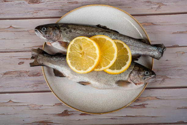 istock fish with lemon - omega 3, vitamin A or E - rainbow trout 1448314132