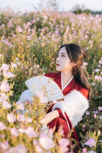 istock Asian Hanfu beauties enjoy life in the flowers at sunset 1448314152