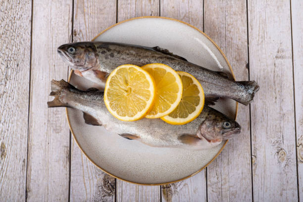 istock fish with lemon - omega 3, vitamin A or E - rainbow trout 1448314749