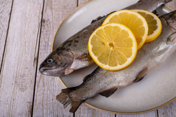 istock fish with lemon - omega 3, vitamin A or E - rainbow trout 1448315074