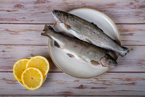 istock fish with lemon - omega 3, vitamin A or E - rainbow trout 1448315557