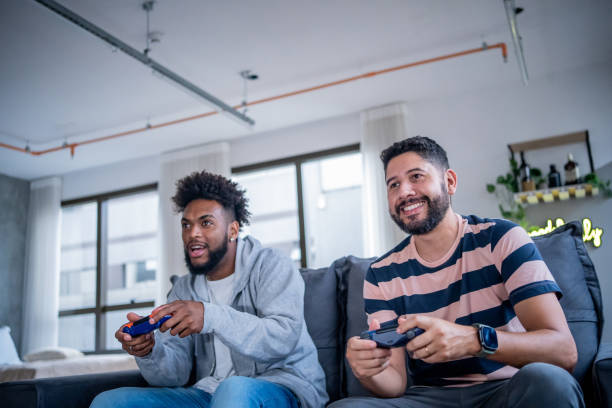 istock Two friends playing video games at home 1448317862