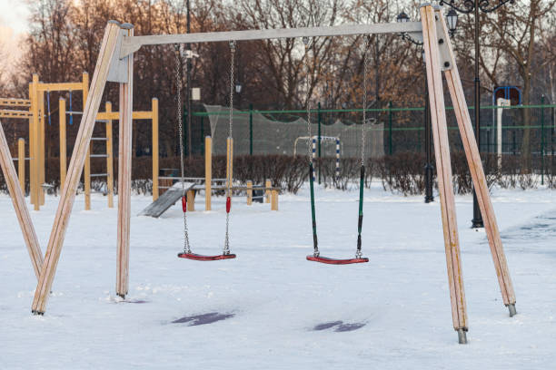 empty swing at the playground in winter. empty swing. playground