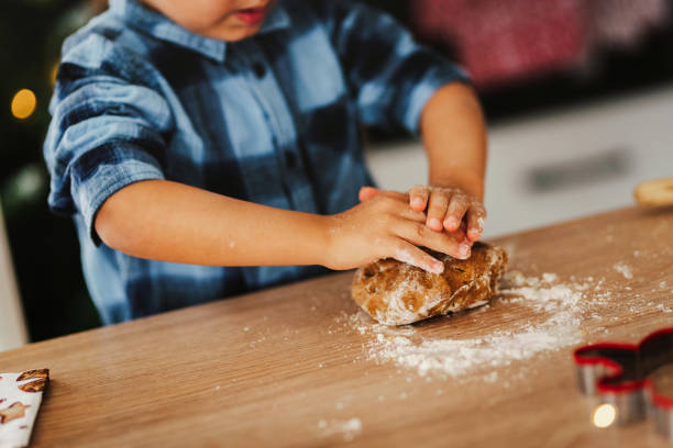 istock Child making Christmas cookies. 1448319400