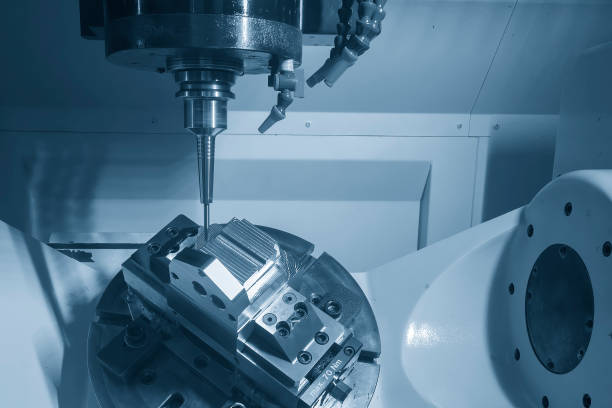 The 5-axis CNC milling machine  cutting the metal mold part. stock photo