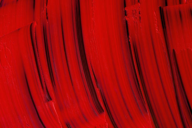 istock Red lipstick texture background. Vertical smears of red lipstick on black. 1448321504