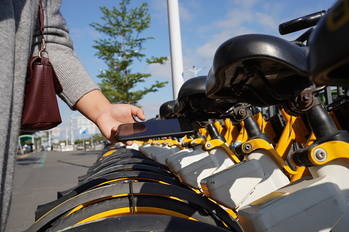 Asian women pay for shared bikes