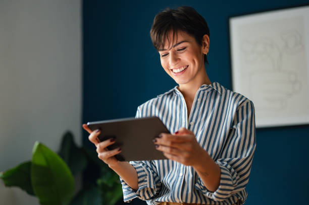 Portrait of a Beautiful Modern Business Woman Using Tablet in Her Office stock photo