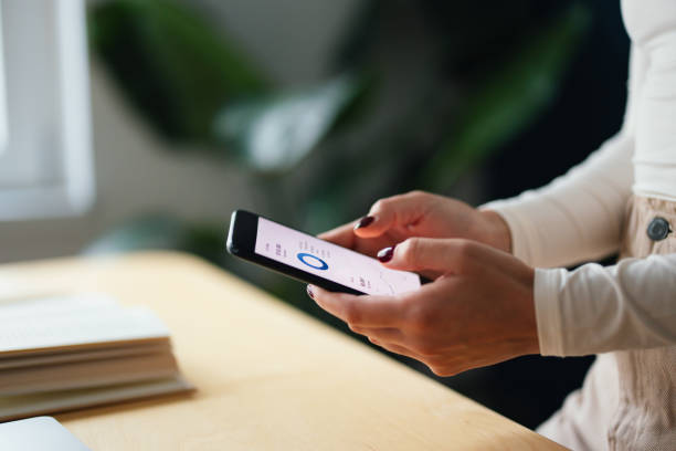 istock Anonymous Woman Using Her Phone at the Office 1448331718