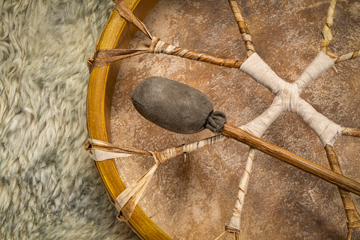 handmade, native American style, shaman frame drum covered by goat skin with a beater