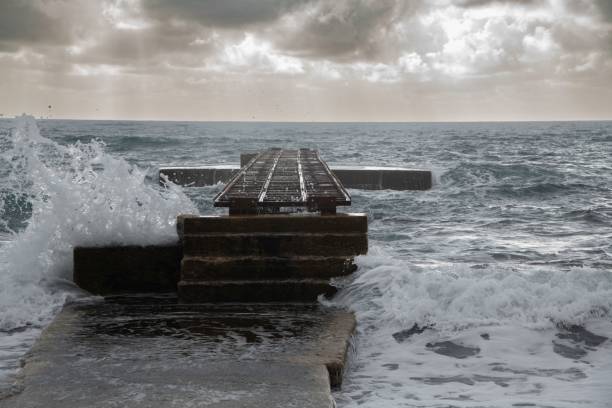 istock old pier at the sea hit by rough waves 1448338167