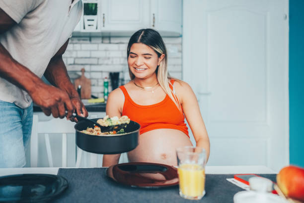 istock Man cooking for his pregnant wife 1448338418