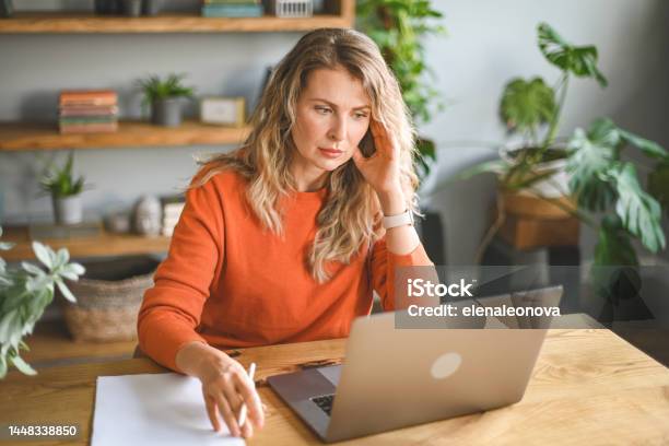 Mature Adult Woman Working At Home Stock Photo - Download Image Now