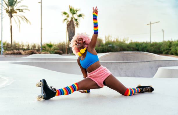Beautiful woman skating with roller skates and having fun. Professional skater and dancer training in the morning wearing colored and fashionable clothes.