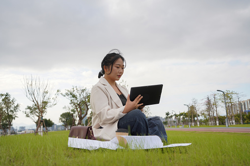 business woman working on the grass