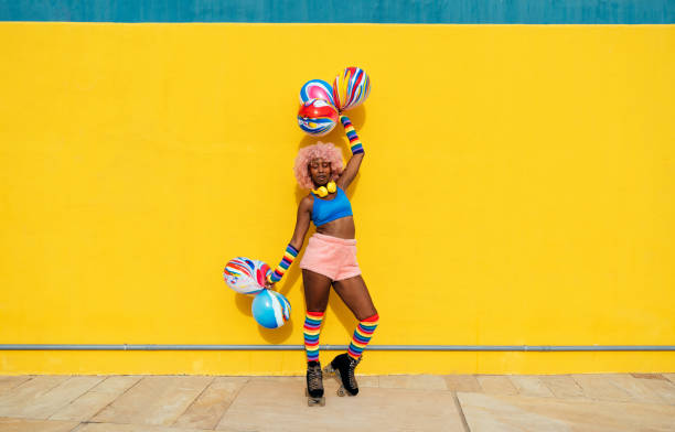 Beautiful woman skating with roller skates and having fun. Professional skater and dancer training in the morning wearing colored and fashionable clothes.