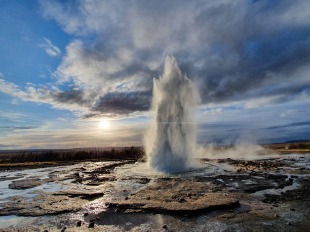 istock Blowing geyser with blue and cloudy sky 1448341277
