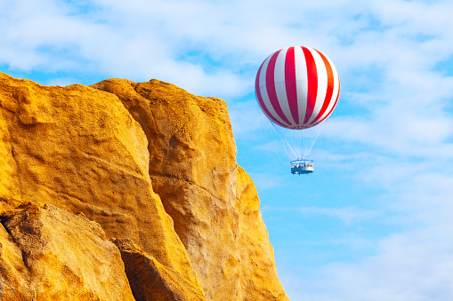 Hot air balloon flying over the mountains . Travel by air