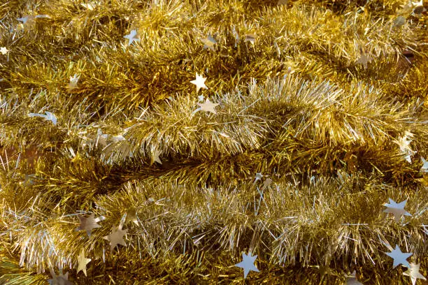 Photo of Shiny gold Christmas tinsel background