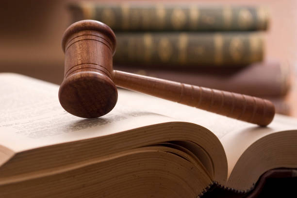 istock Court gavel resting on law book. 1448344030