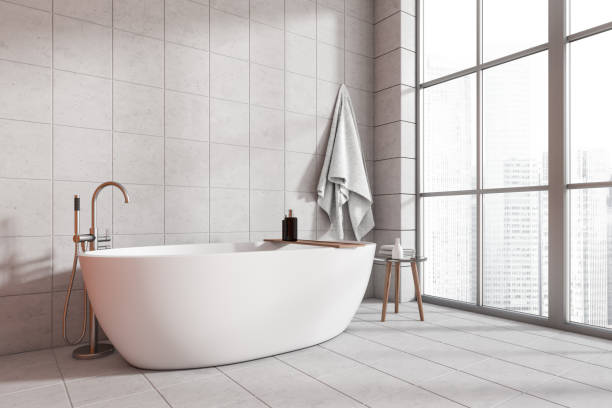 istock Corner view on bright bathroom interior with bathtub, panoramic window 1448344188