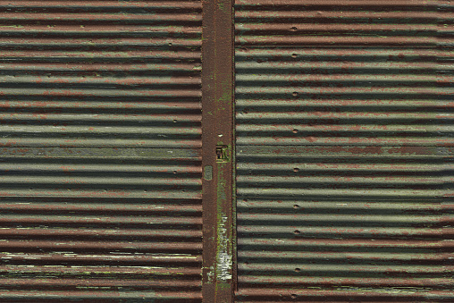 Old weathered and rusty steel door for background