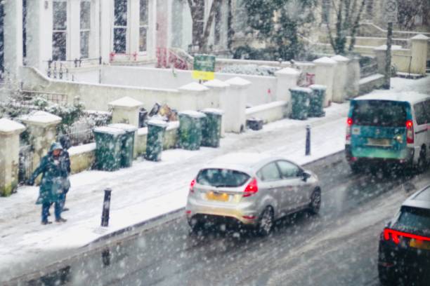 Stuck traffic in the snow. Traffic jam during the first snowfall in Brighton, winter 2022, afternoon of the 12 December. Captured on Preston Rd. Snow is quite rare in Brighton and on the English Southcoast