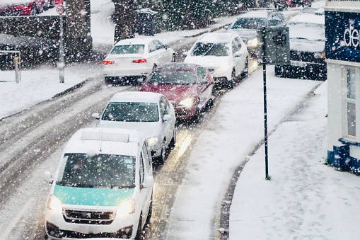 Stuck traffic in the snow. Traffic jam during the first snowfall in Brighton, winter 2022, afternoon of the 12 December. Captured on Preston Rd. Snow is quite rare in Brighton and on the English Southcoast