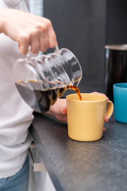 istock Woman Pouring Coffee at Home 1448346625