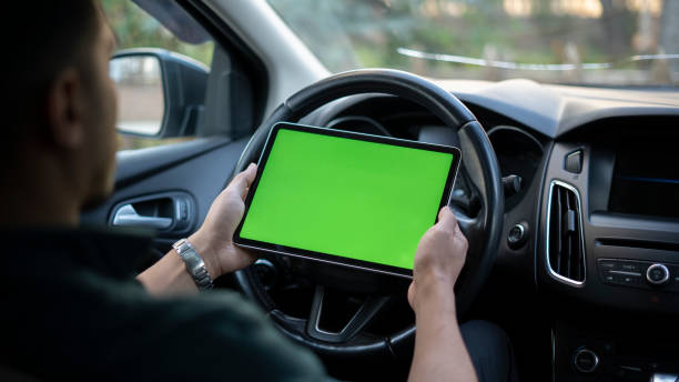istock Businessman showing mock up screen with digital tablet in car 1448346706