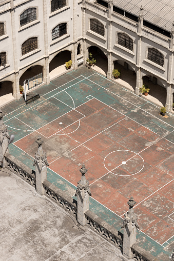 basketball and soccer fields inside a school, classical architecture and decoration, scene without people