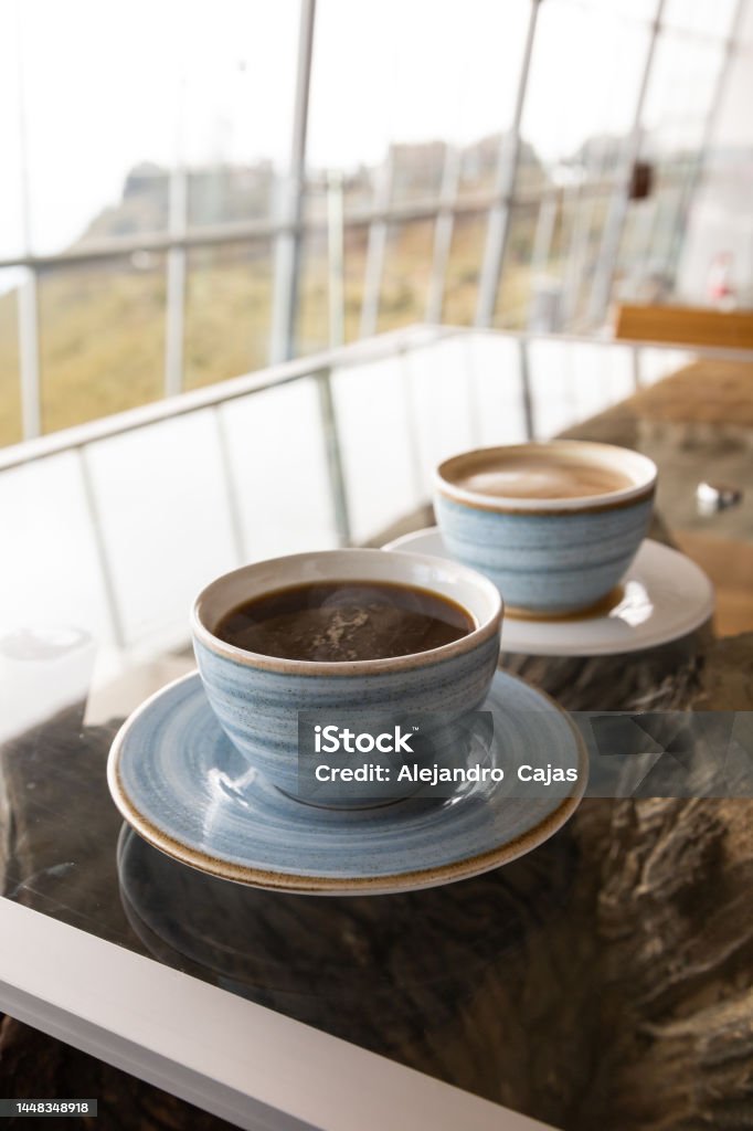 decorated crockery, hot drink in restaurant, caffeinated breakfast served table with cup of coffee and latte, light blue decorated crockery, hot drink in restaurant Bowl Stock Photo