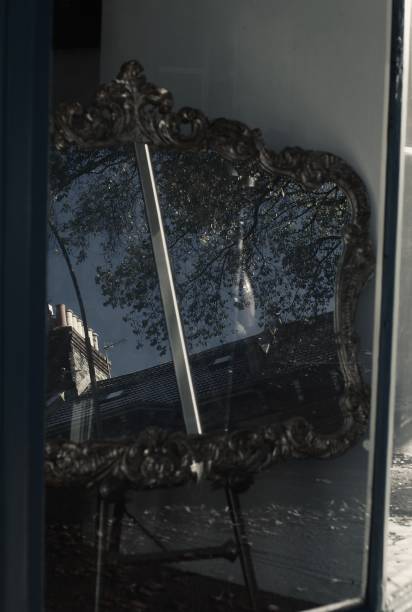 istock Old antique mirror reflecting the street 1448349159