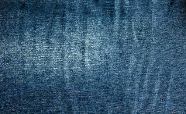 istock Blue denim background. Texture of classic frayed jeans 1448353328