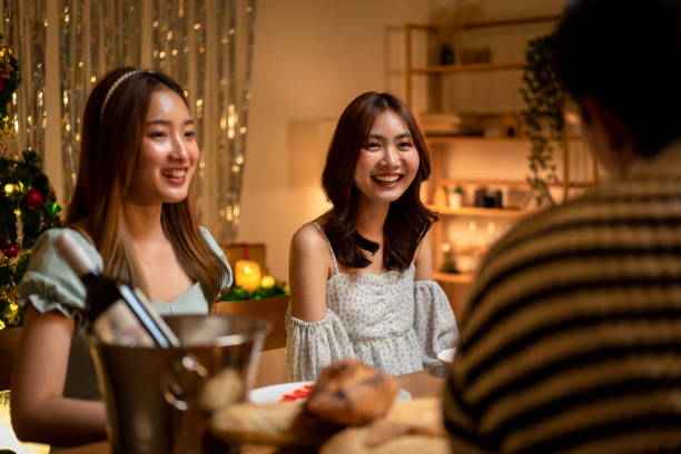 istock Young people talking and eating dinner while celebration and toasting with champagne together in holiday 1448353664